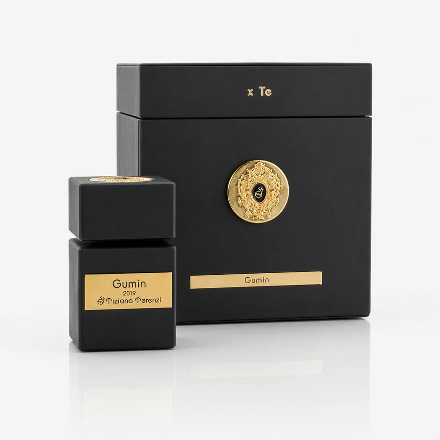 Gumin Extrait de Parfum 100ml – bottle beside its black gift box with gold emblem