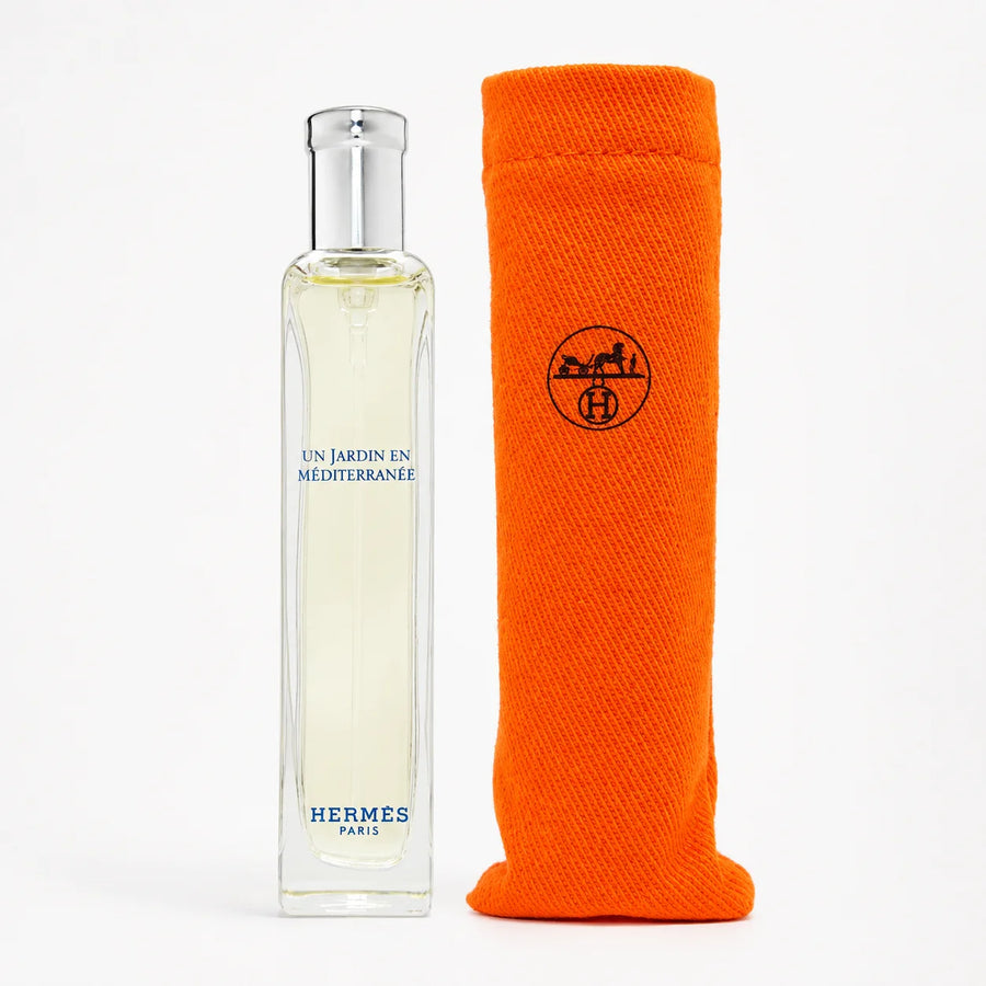 Hermès Un Jardin en Méditerranée EDT 15ml Miniature Unisex Fragrance – bottle standing beside an orange travel pouch
