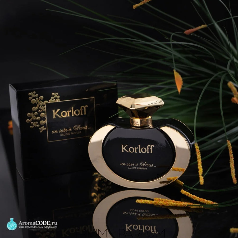Korloff Un Soir À Paris Eau De Parfum 100ML – bottle and box on a dark surface with grasses