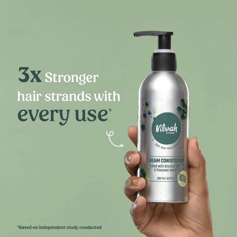 Vilvah Cream Conditioner – hand holding the bottle, stronger strands claim
