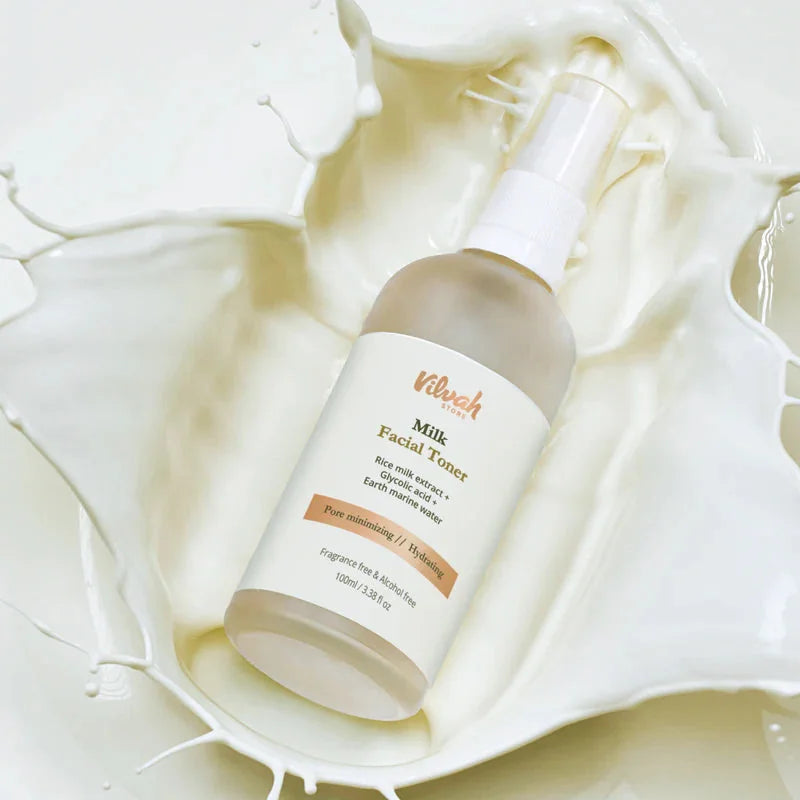 Vilvah Milk Face Toner 100ml – frosted spray bottle lying in a splash of milk